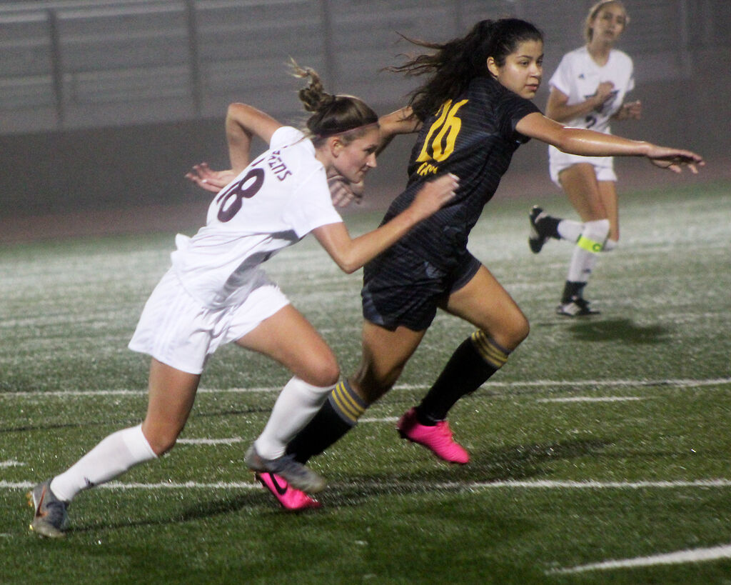 Freshman Olivia Wheeler of Stephens College chases a ball with Isabelle Conte of Ottawa University on Wednesday